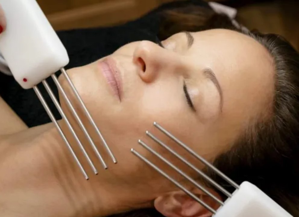 Multi-probe microcurrent applicators worked along the jawline and cheek.